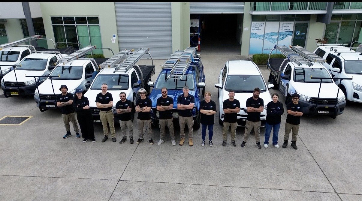 The All Roofing Services team with the company ute fleet outside the workshop